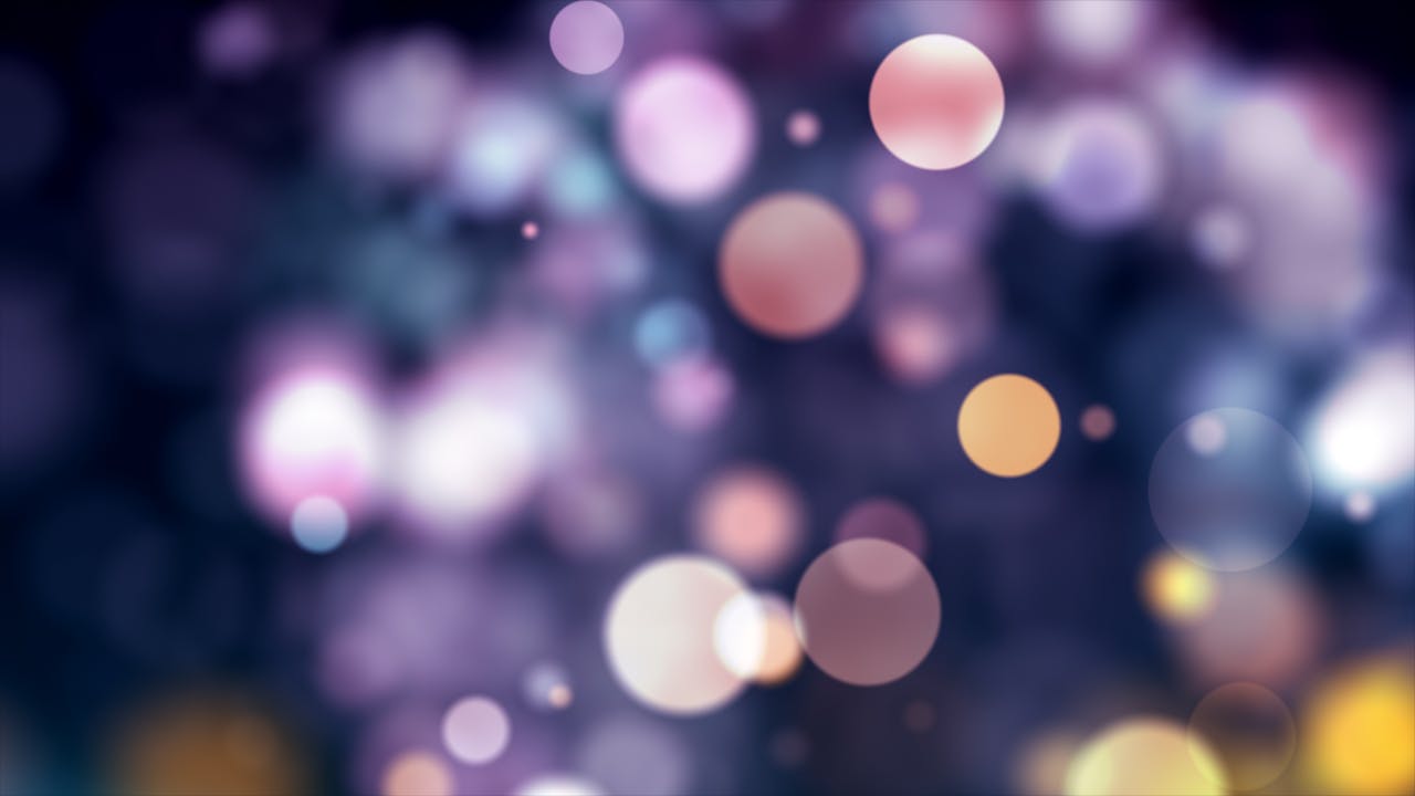 Vibrant abstract bokeh background with colorful lights and sparkles.